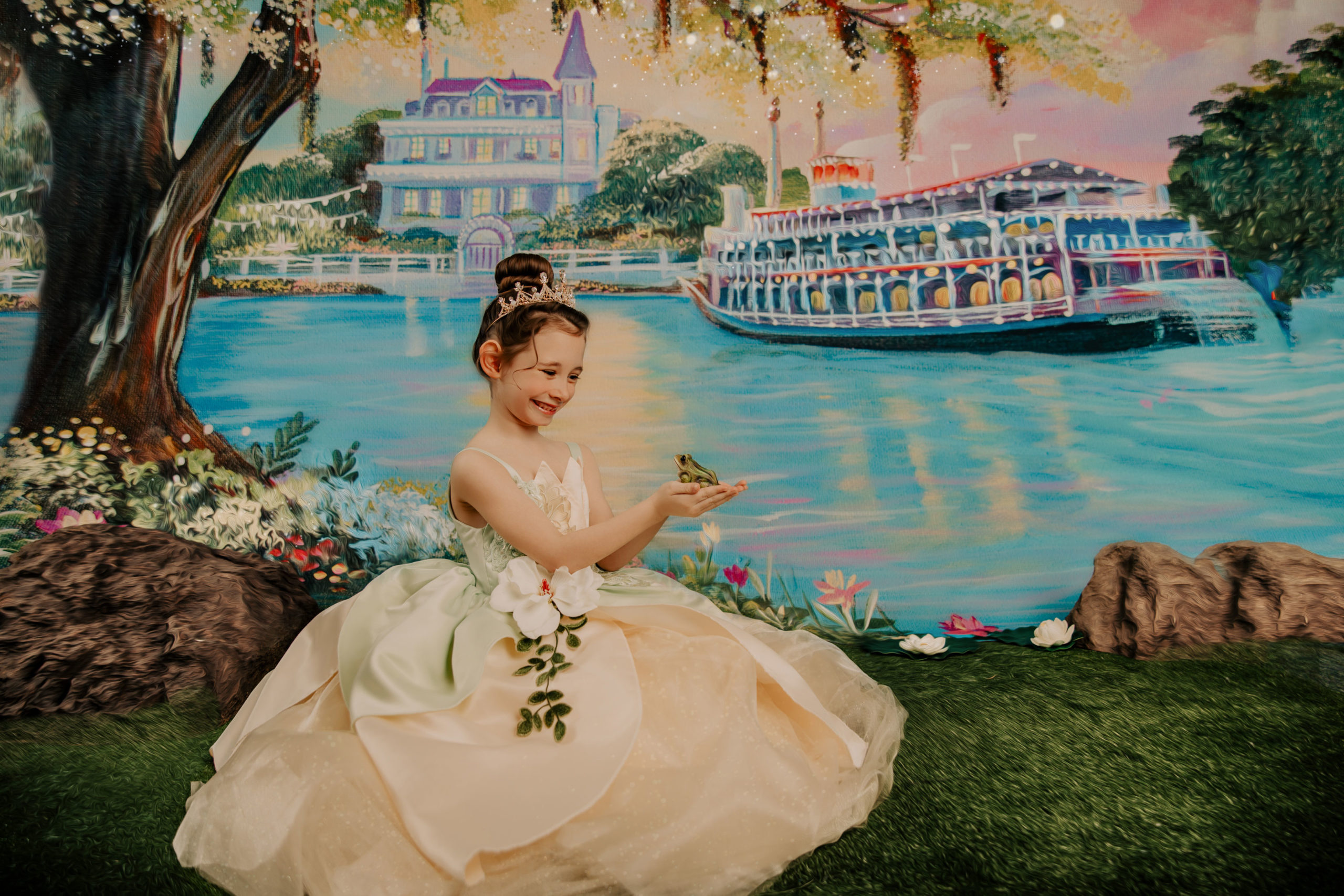 Princess and the frog inspired scene with a girl in a yellow and green dress holding a frog