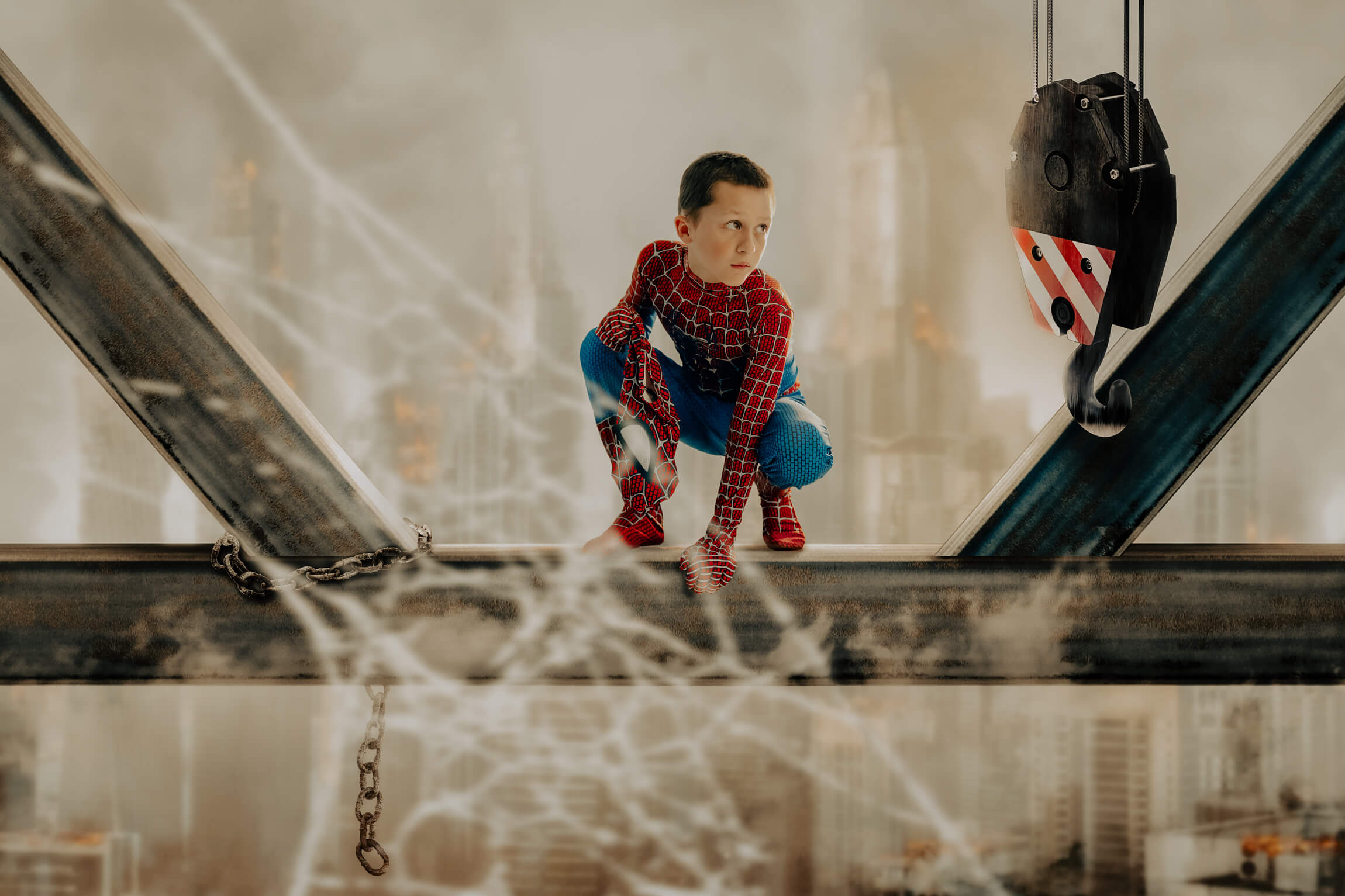 Boy dressed up as spiderman overlooking the city